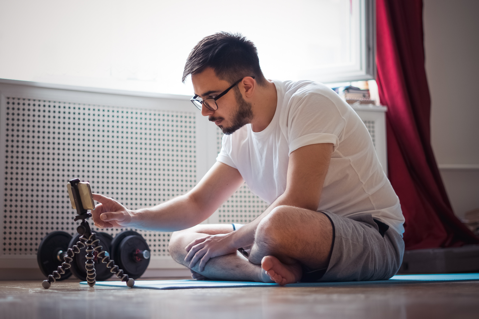 Exercises at home, watching videos from mobile phone.